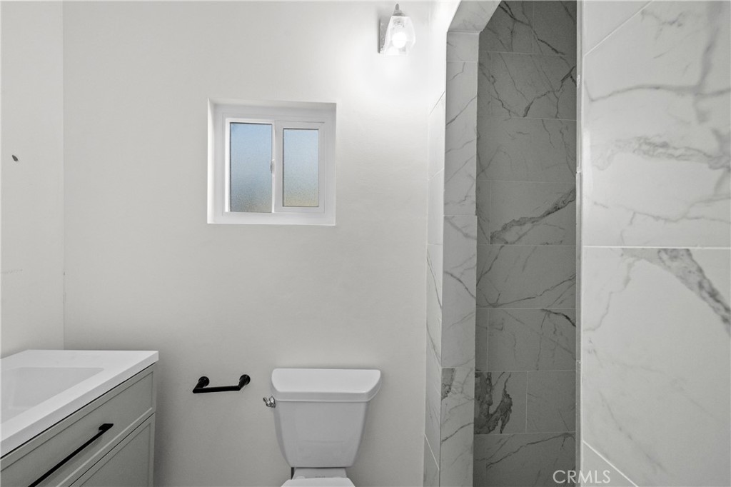 2603 Calle Del Comercio, Unit B San Clemente, CA 92672 - Photo 6 of 18 a white toilet sitting next to a bathroom sink