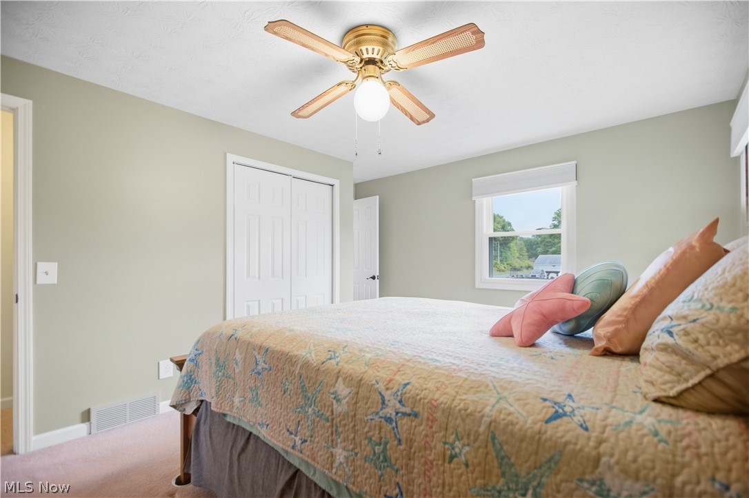 5972 Keller Road Akron, OH 44319 - Photo 16 of 29 Recessed window with white trim, ceiling fan with wood-finish blades, and bi-fold closet doors