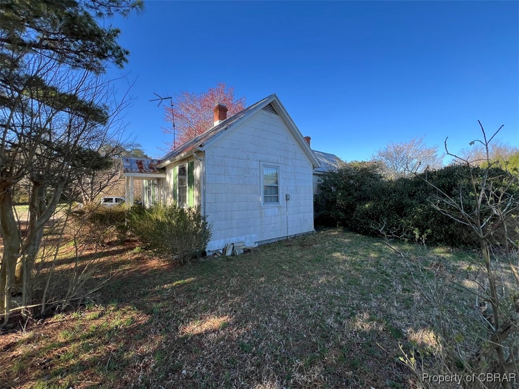 517 Mill Wharf Road Wake, VA 23176 - Photo 5 of 6 View of side of property featuring a yard and a chimney