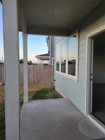 a kitchen with a refrigerator and white cabinets