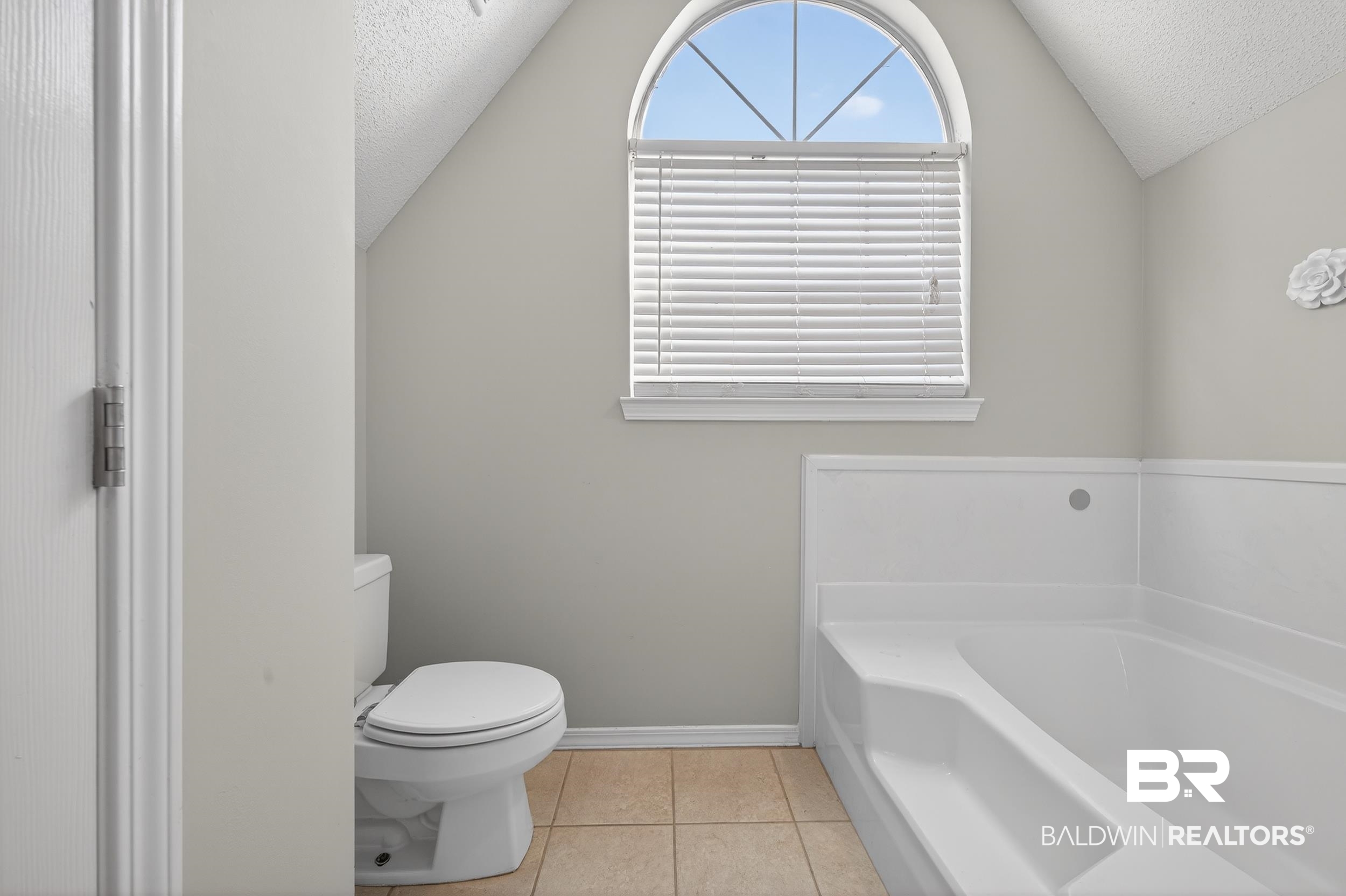 7050 Highpointe Place West Daphne, AL 36527 - Photo 51 of 66 Bathroom featuring a textured ceiling, a garden tub, and light tile patterned floors