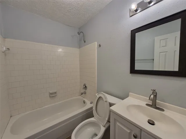a bathroom with a toilet sink and bathtub