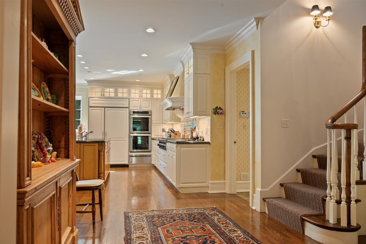5 Woodley Road Winnetka, IL 60093 - Photo 20 of 48 a living room with stainless steel appliances furniture a rug and a view of kitchen