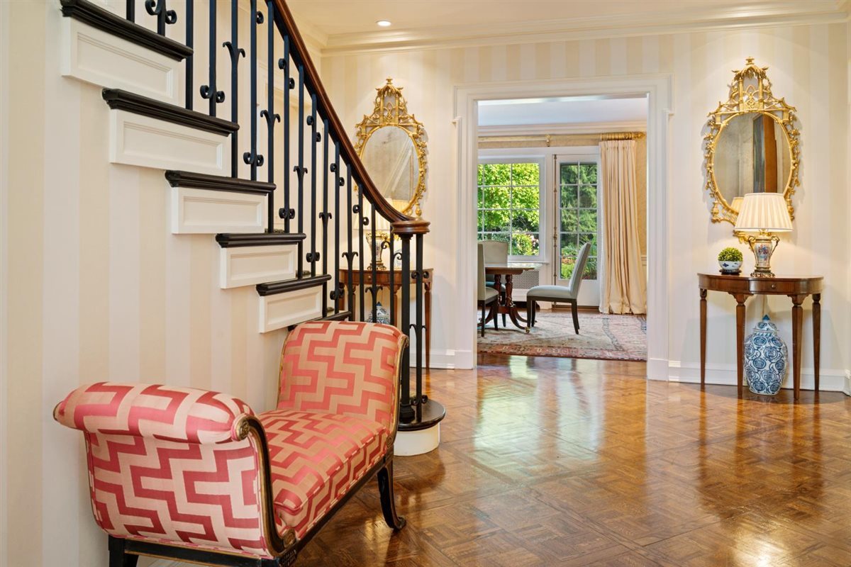 5 Woodley Road Winnetka, IL 60093 - Photo 3 of 48 a hallway with wooden floor stairs and furniture