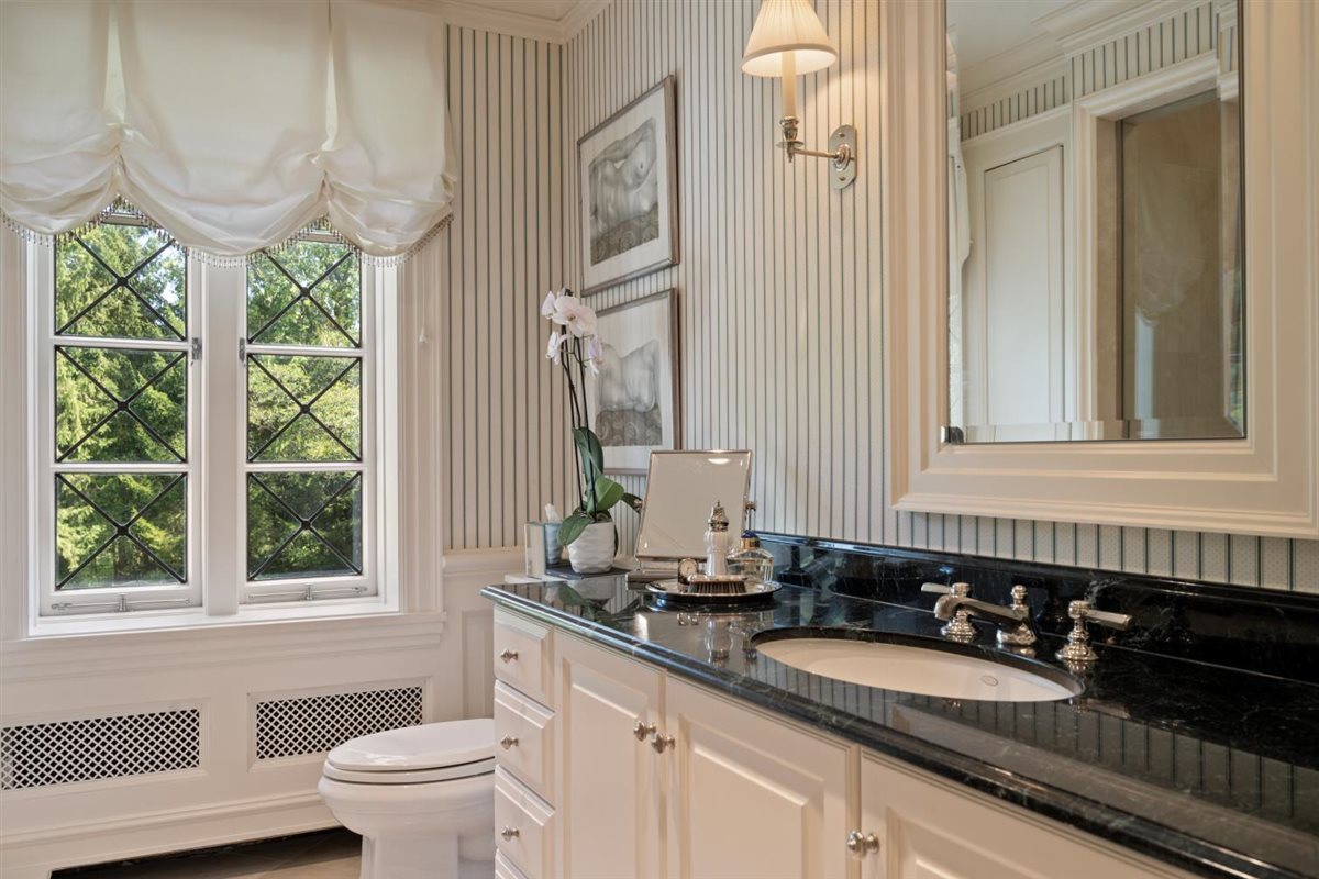 5 Woodley Road Winnetka, IL 60093 - Photo 35 of 48 a bathroom with a granite countertop sink and a mirror