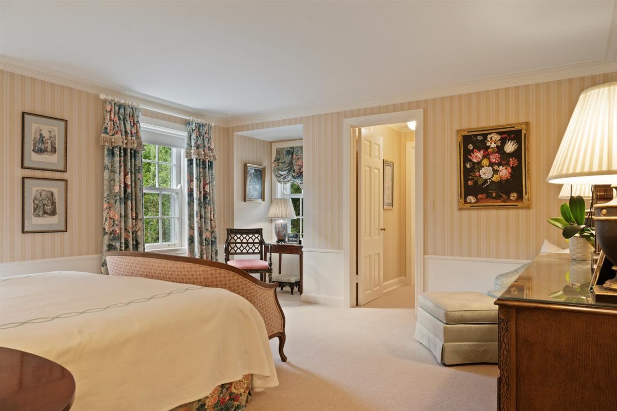 5 Woodley Road Winnetka, IL 60093 - Photo 36 of 48 a bedroom with a bed and large windows