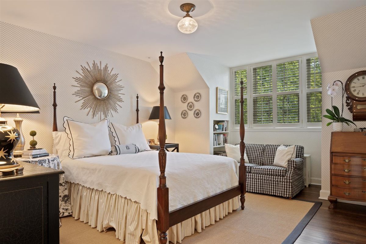 5 Woodley Road Winnetka, IL 60093 - Photo 37 of 48 a bedroom with a bed and a chandelier