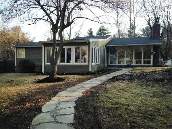 a front view of a house with garden