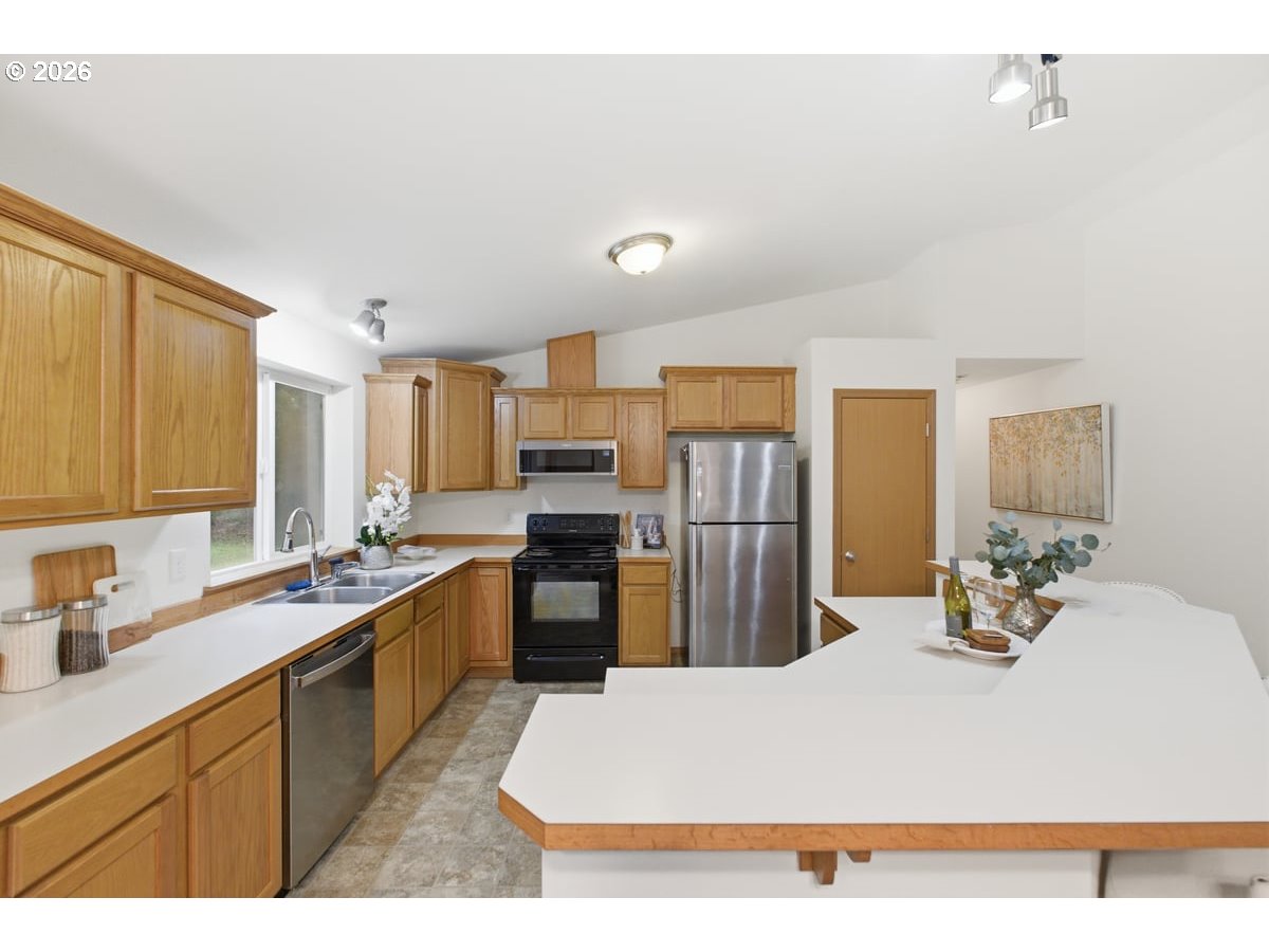 37905 South Wilhoit Road Molalla, OR 97038 - Photo 5 of 48 a large white kitchen with a refrigerator a stove a sink dishwasher and wooden cabinets with wooden floor