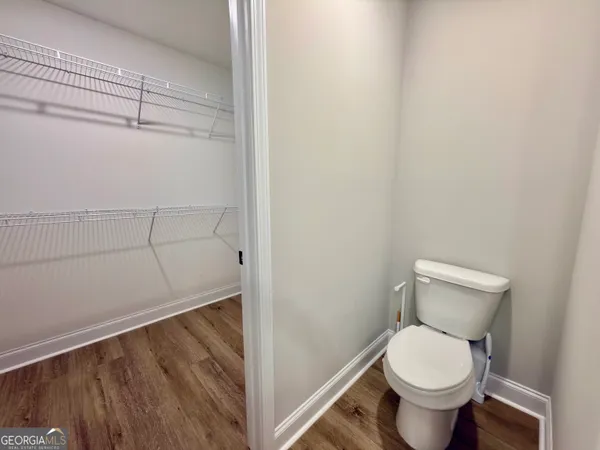 a white toilet sitting next to a shower