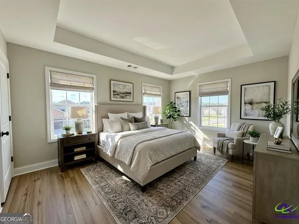 a bedroom with a bed and wooden floor