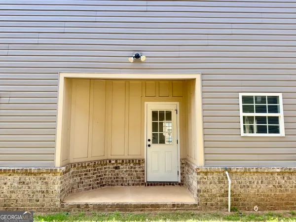 a view of a house with a door and a window