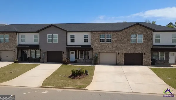 a front view of a house with yard