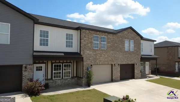 a front view of a house with yard