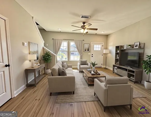a living room with furniture and a flat screen tv