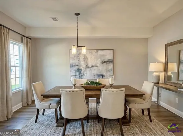 a view of a dining room with furniture window and wooden floor