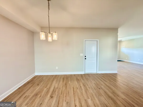 a view of a room with wooden floor and window