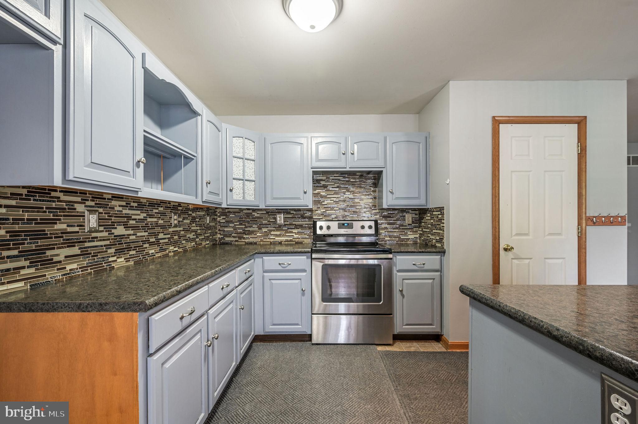 113 Fieldbrook Drive Magnolia, DE 19962 - Photo 12 of 38 a kitchen with stainless steel appliances granite countertop a sink and a stove