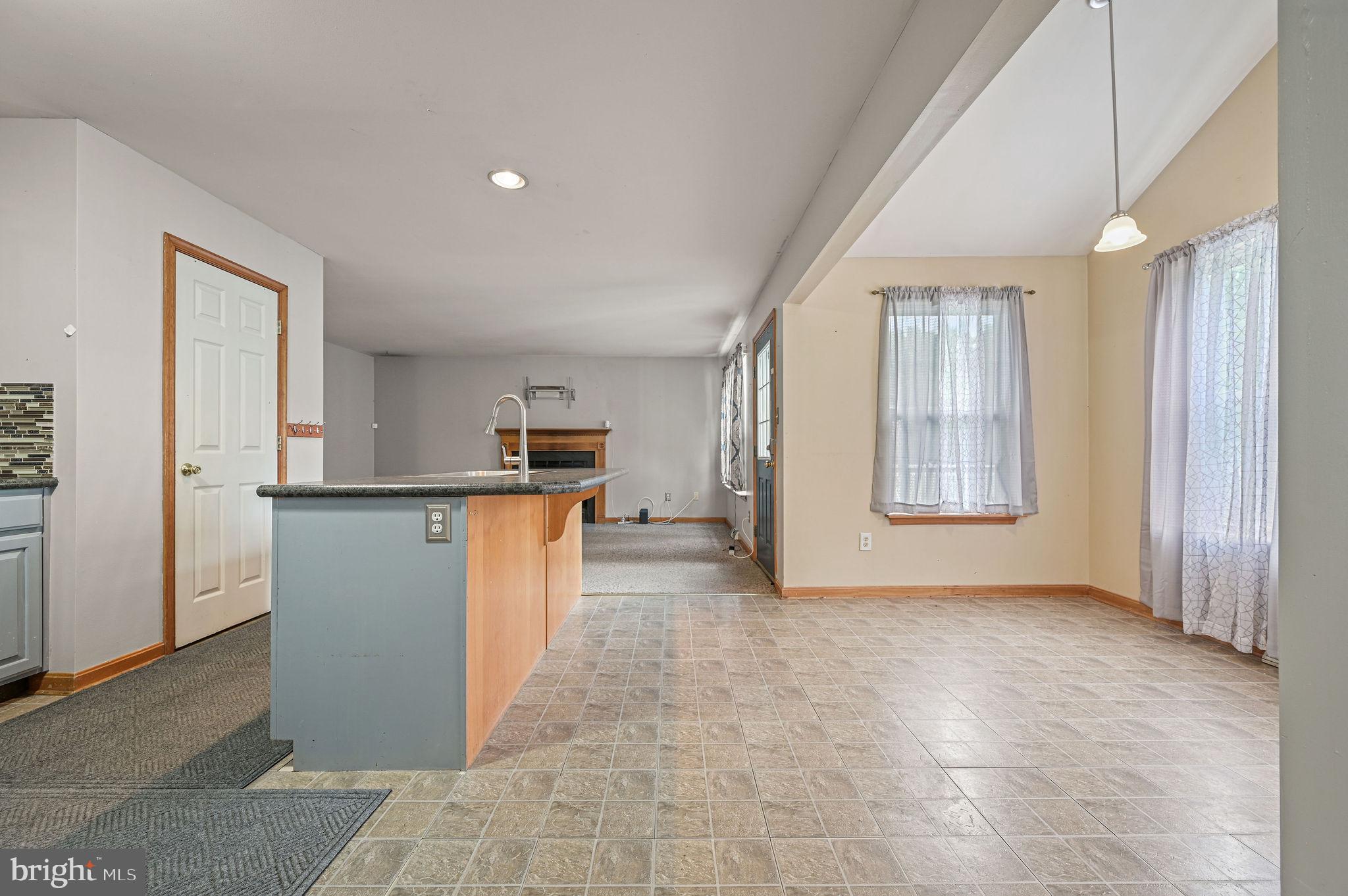 113 Fieldbrook Drive Magnolia, DE 19962 - Photo 15 of 38 an empty room with kitchen and windows