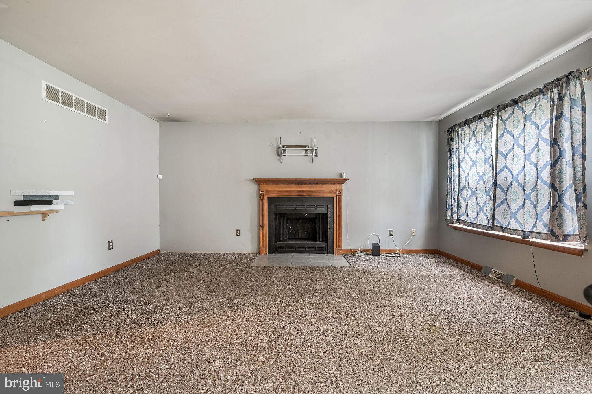 113 Fieldbrook Drive Magnolia, DE 19962 - Photo 8 of 38 a view of an empty room with a fireplace and a window