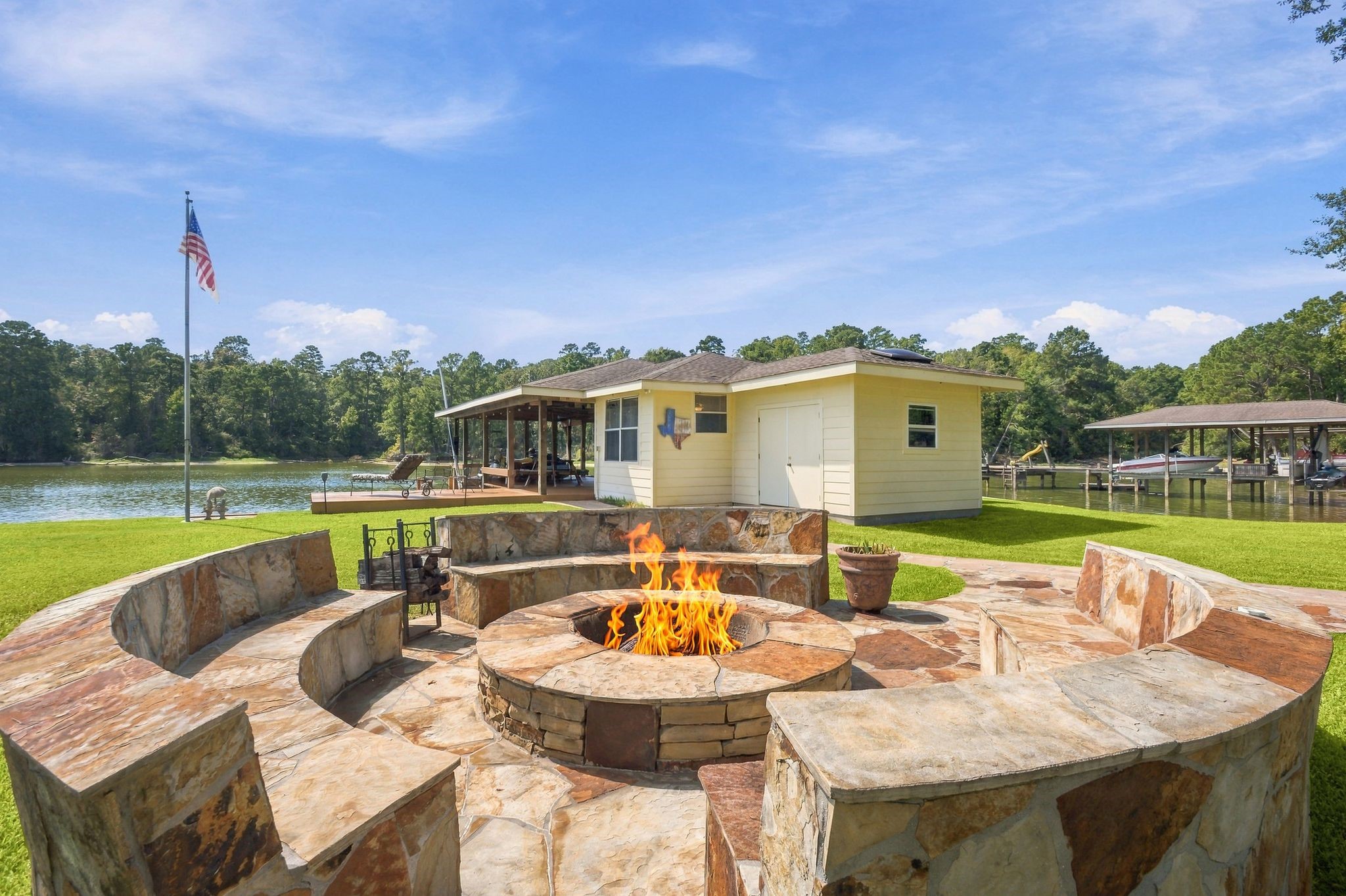 20341 Bay Hill Road Point Blank, TX 77364 - Photo 39 of 50 Experience lakeside tranquility with this charming property featuring a spacious stone fire pit, perfect for cozy gatherings, and a private dock for water activities.