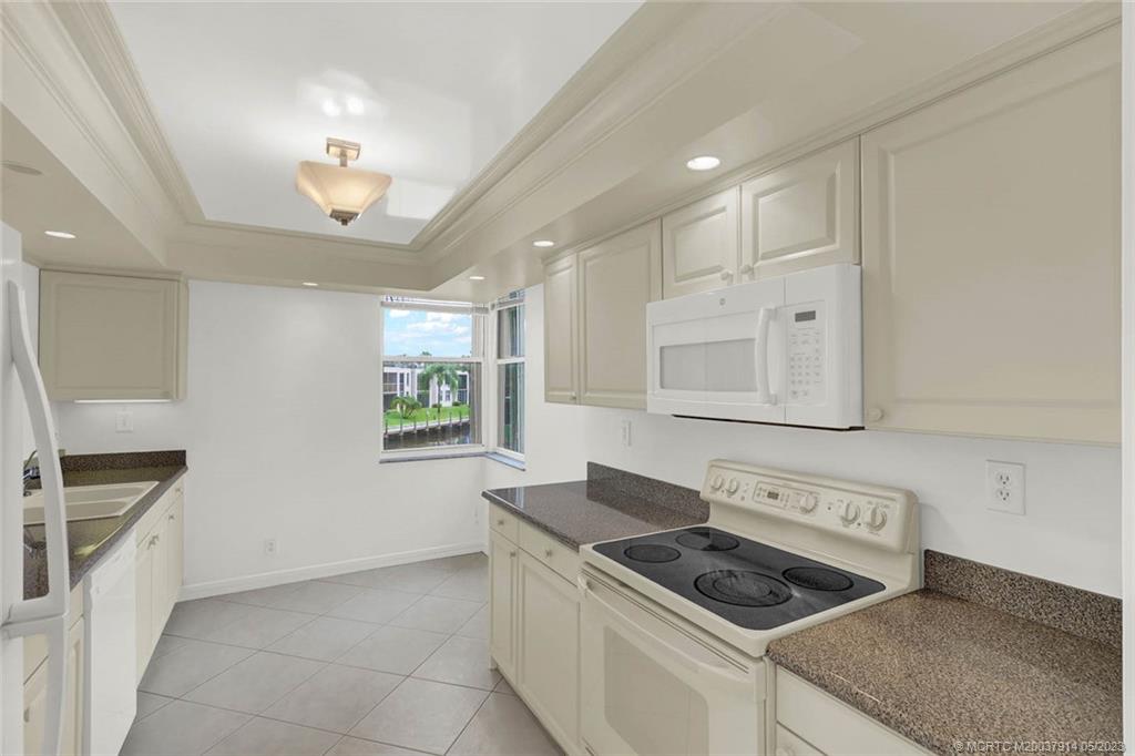 1950 Southwest Palm City Road, Unit 14207 Stuart, FL 34994 - Photo 17 of 50 a kitchen that has a sink and a stove