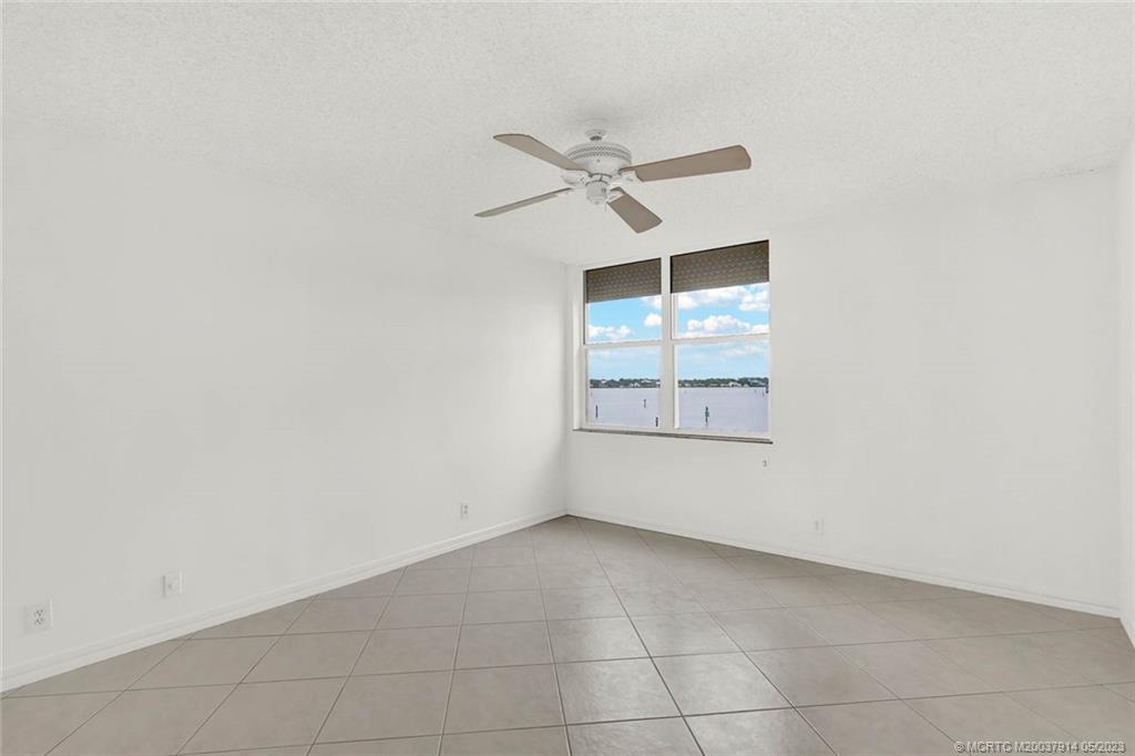 1950 Southwest Palm City Road, Unit 14207 Stuart, FL 34994 - Photo 21 of 50 an empty room with a window and ceiling fan