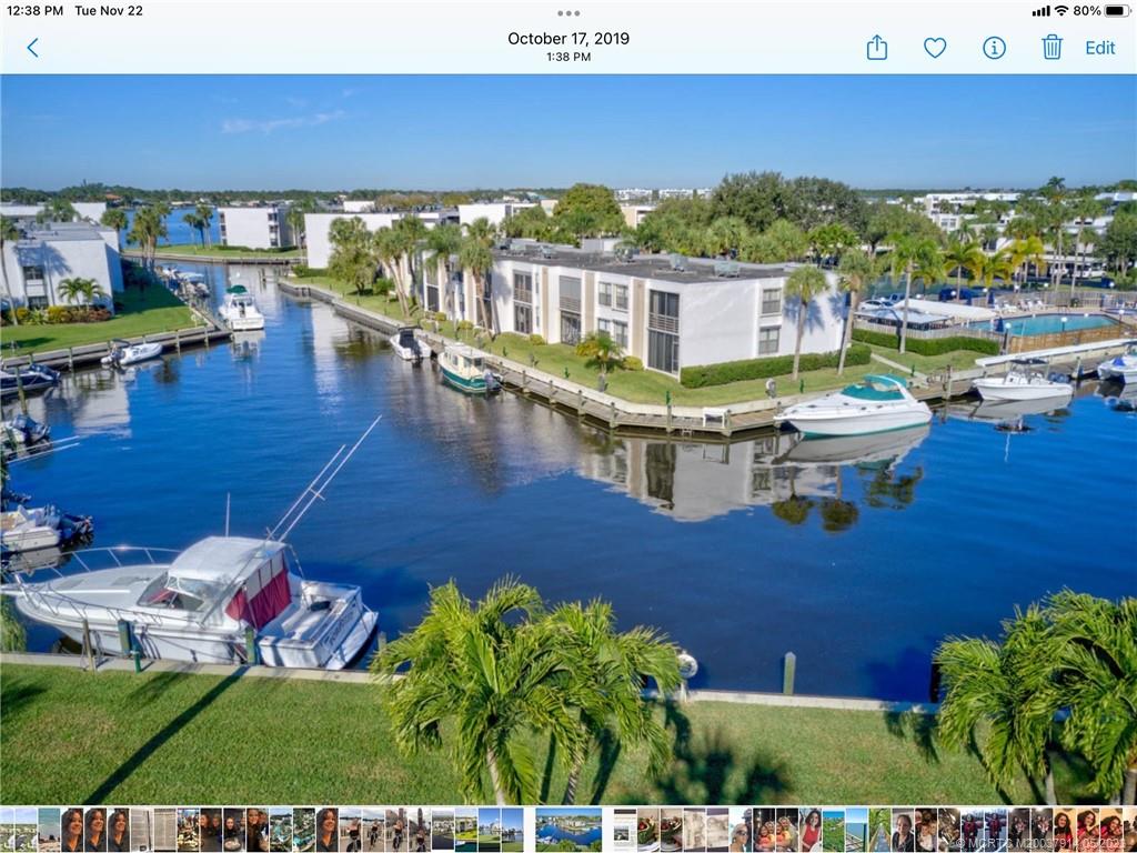 1950 Southwest Palm City Road, Unit 14207 Stuart, FL 34994 - Photo 34 of 50 a view of a chairs and table in a terrace
