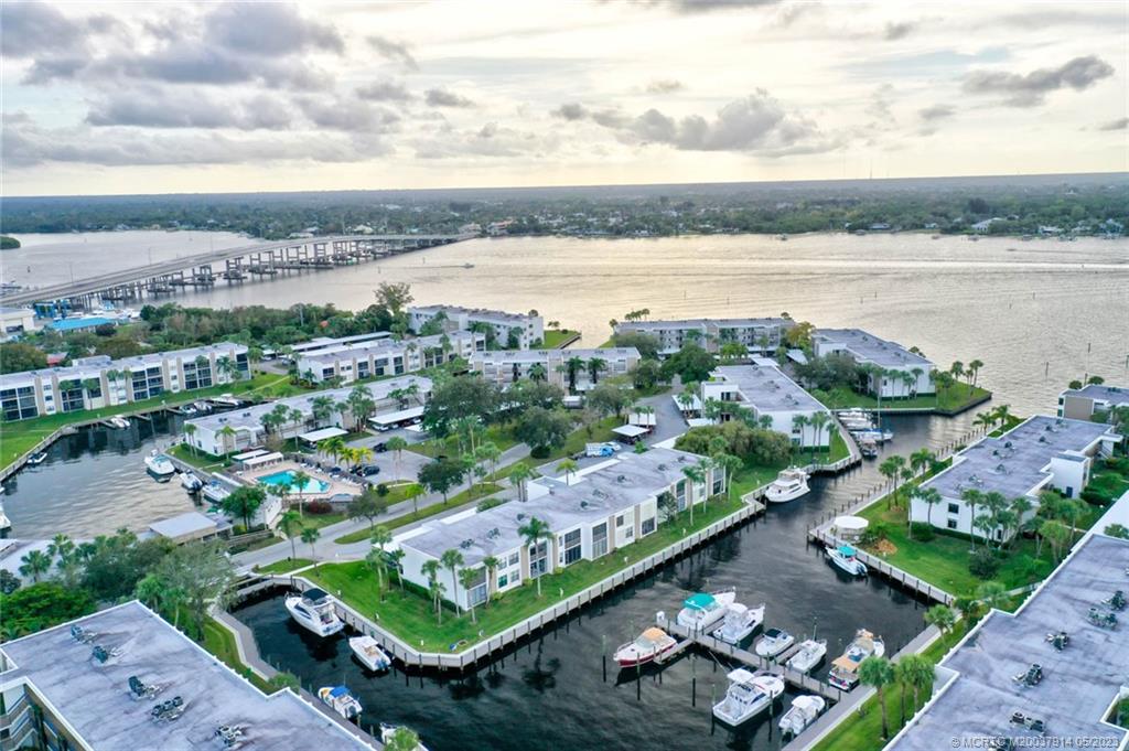 1950 Southwest Palm City Road, Unit 14207 Stuart, FL 34994 - Photo 7 of 50 an aerial view of a city with lots of residential buildings ocean and mountain view in back