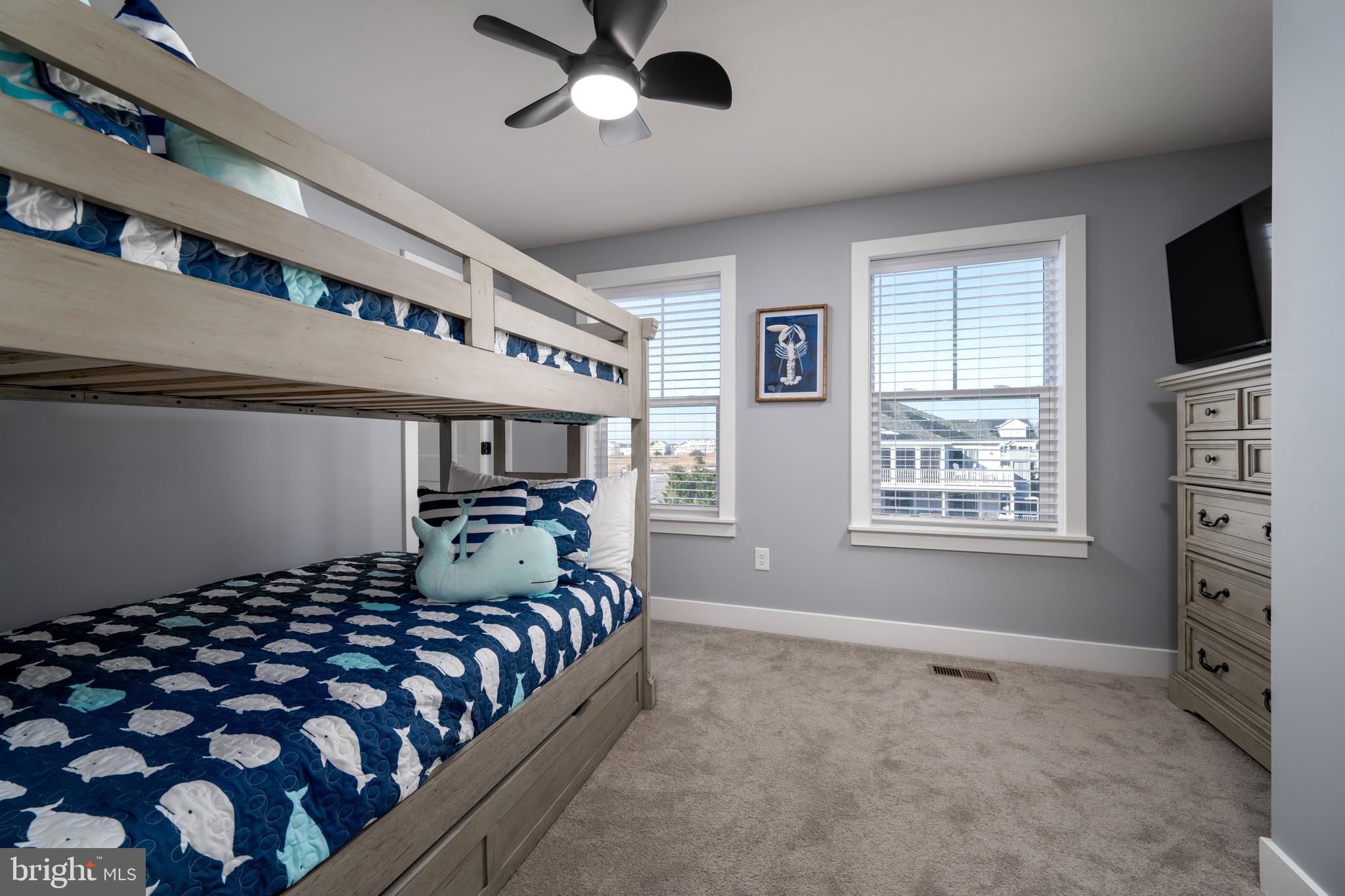 39546 Admiral Road Bethany Beach, DE 19930 - Photo 29 of 73 a bedroom with a bed and a flat tv screen on the dresser