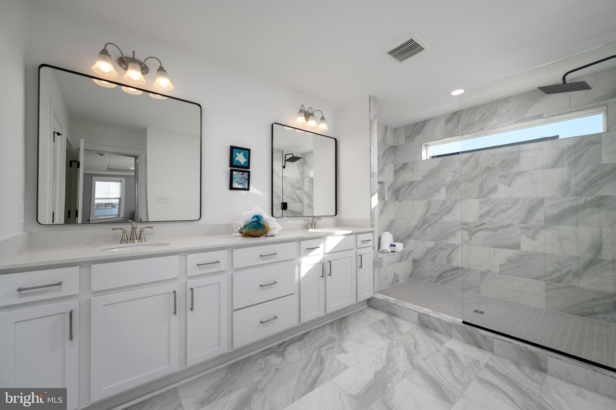 39546 Admiral Road Bethany Beach, DE 19930 - Photo 39 of 73 a spacious bathroom with double sink and a mirror