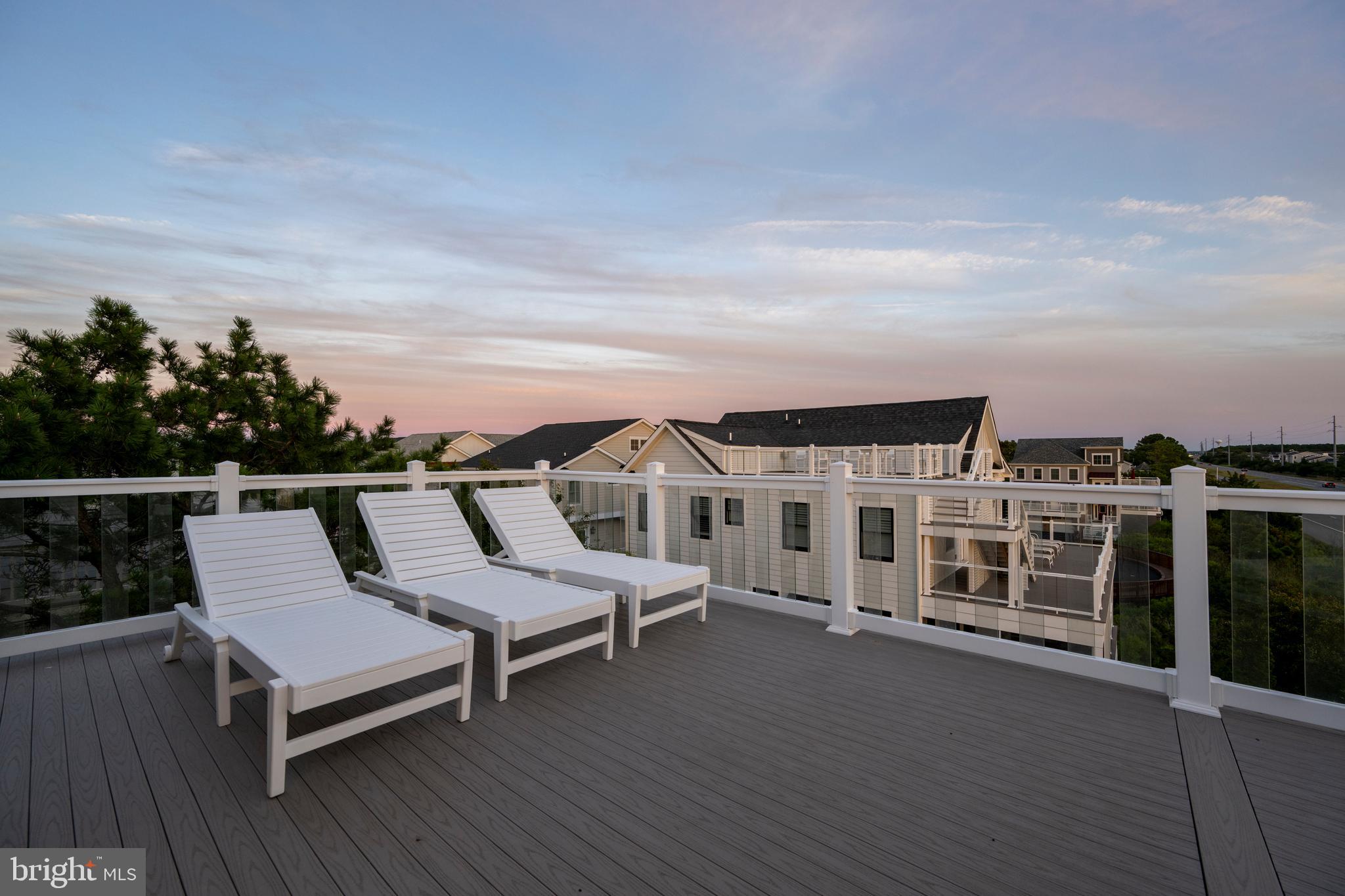 39546 Admiral Road Bethany Beach, DE 19930 - Photo 69 of 73 a view of a balcony with two chairs and wooden floor