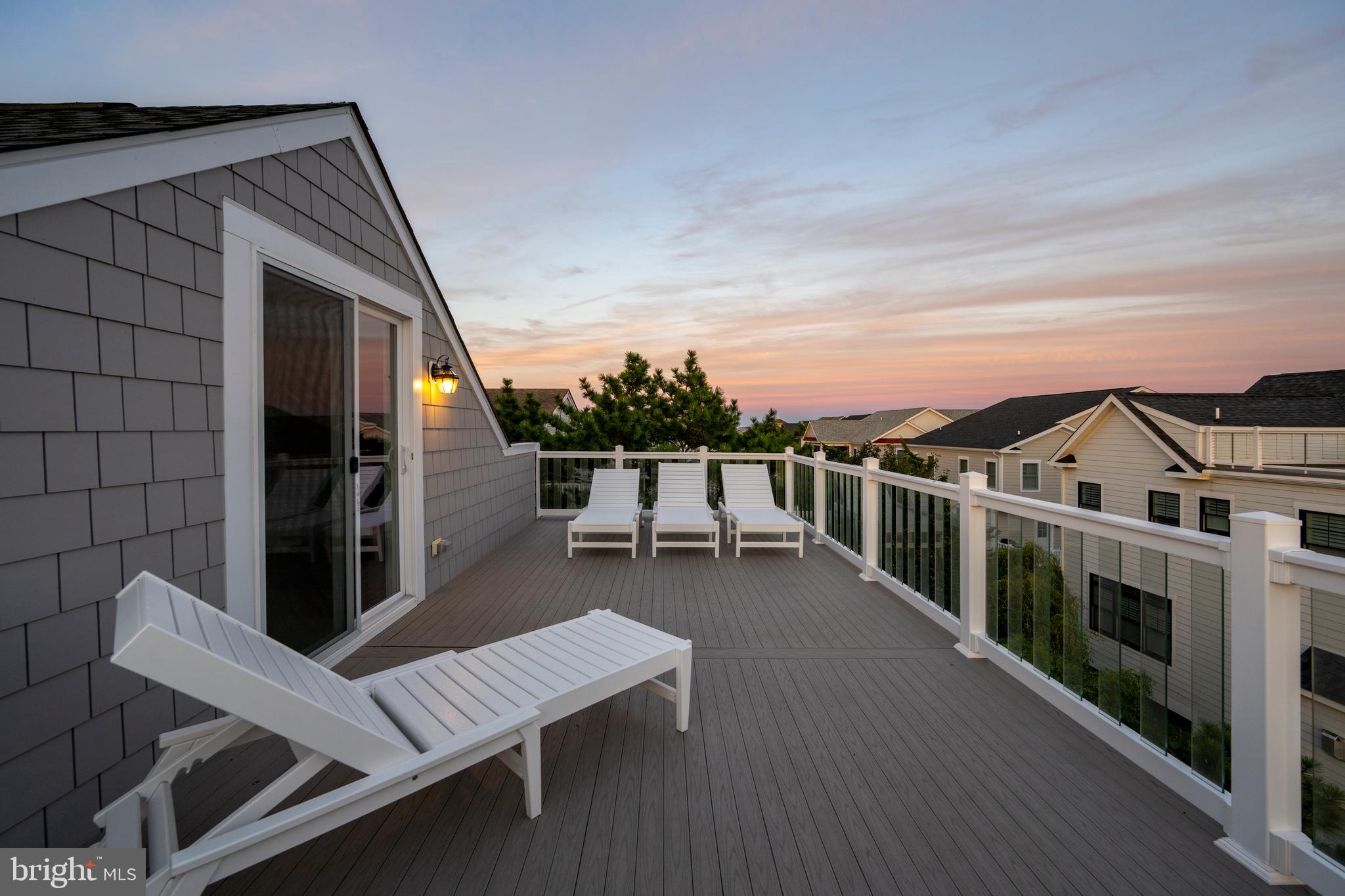 39546 Admiral Road Bethany Beach, DE 19930 - Photo 70 of 73 a view of a patio with wooden floor and iron fence