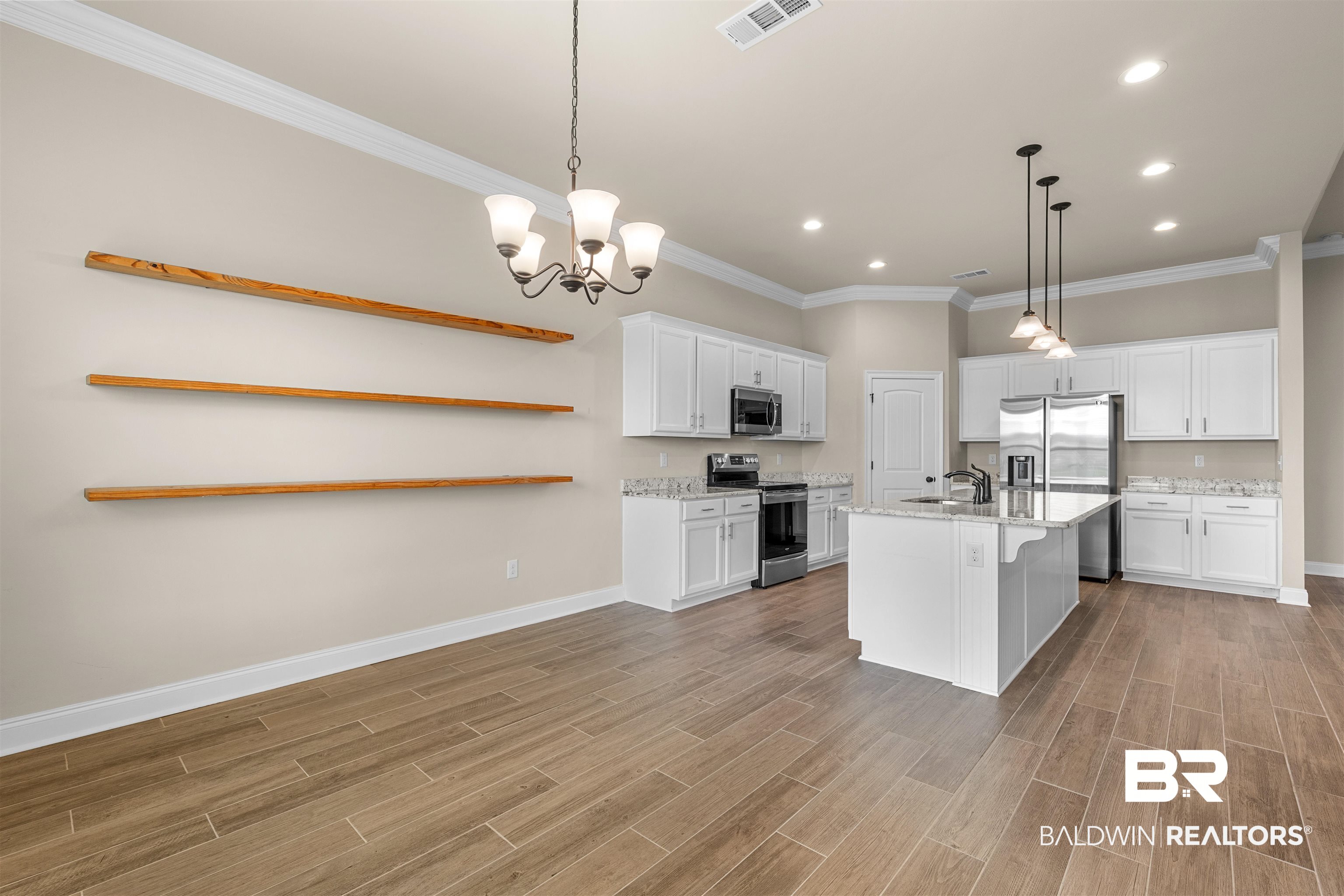 991 Dalton Circle Foley, AL 36535 - Photo 11 of 35 Kitchen featuring appliances with stainless steel finishes, open shelves, crown molding, white cabinetry, and light wood-style flooring