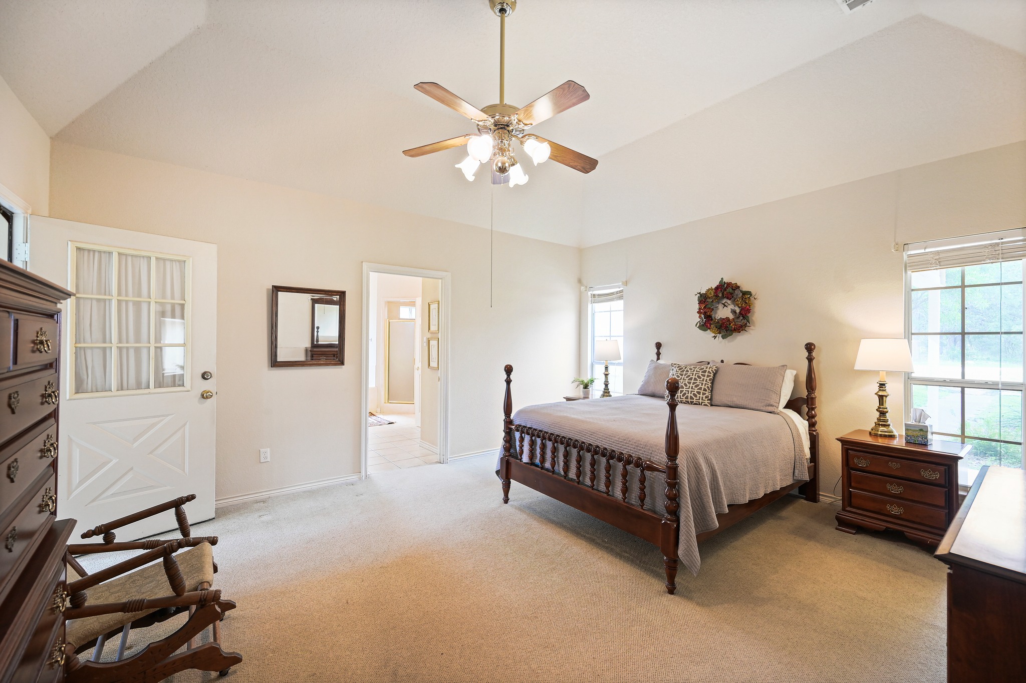 364 Nameless Road Driftwood, TX 78619 - Photo 16 of 32 The primary suite has high ceilings and a nice sized bedroom that leads out onto the sunporch (secondary living space).