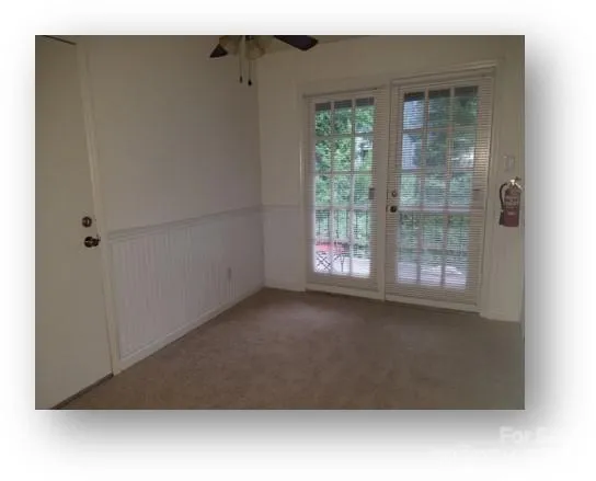 a kitchen with stainless steel appliances a refrigerator a stove a microwave and white cabinets