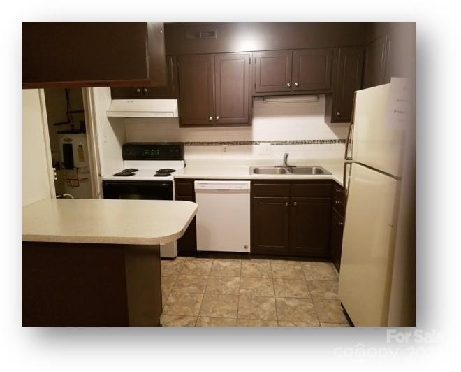 153 West End Street Chester, SC 29706 - Photo 21 of 27 a kitchen with stainless steel appliances a refrigerator a stove a microwave and white cabinets