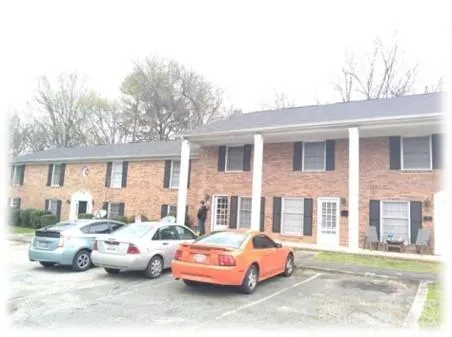a front view of a house with parking space