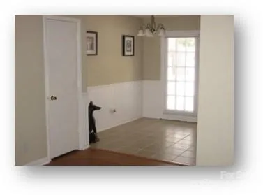 a view of a oven with white cabinets