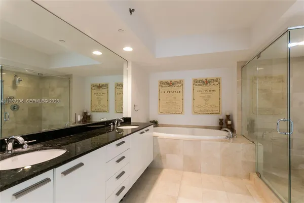 a spacious bathroom with a bathtub sink and mirror