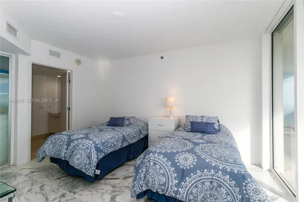a bedroom with two beds and painted walls