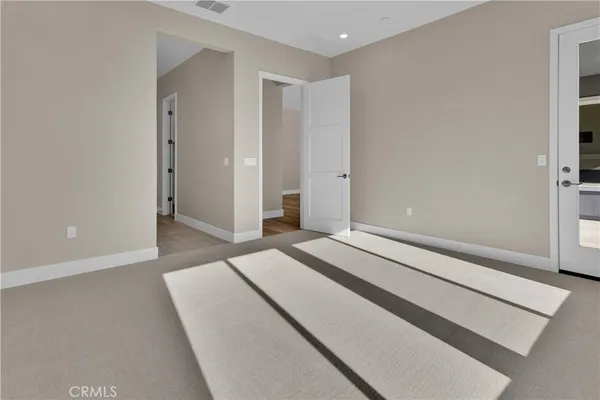 a spacious bedroom with a bed and a window