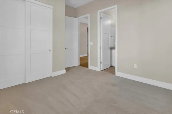 a view of an empty room with closet area