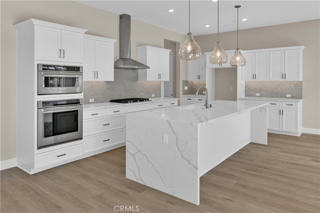 1324 Cava Road Paso Robles, CA 93446 - Photo 2 of 15 a kitchen with stainless steel appliances kitchen island granite countertop a sink a stove and a wooden floors