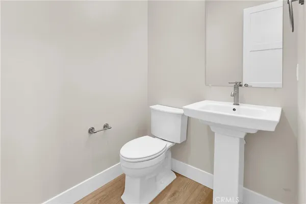 a bathroom with a sink toilet and a mirror