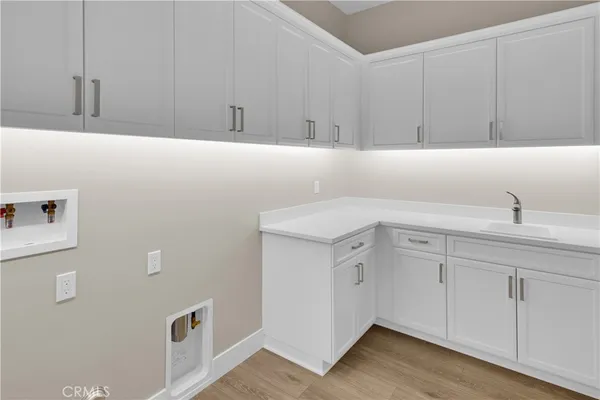 a bathroom with a sink and cabinets
