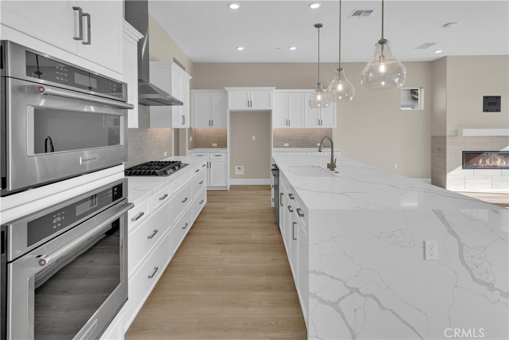 1324 Cava Road Paso Robles, CA 93446 - Photo 3 of 15 a large kitchen with stainless steel appliances kitchen island granite countertop a stove a sink and a refrigerator