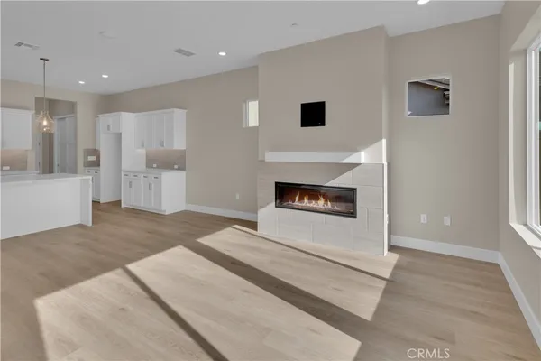 a view of kitchen with granite countertop cabinets and fireplace