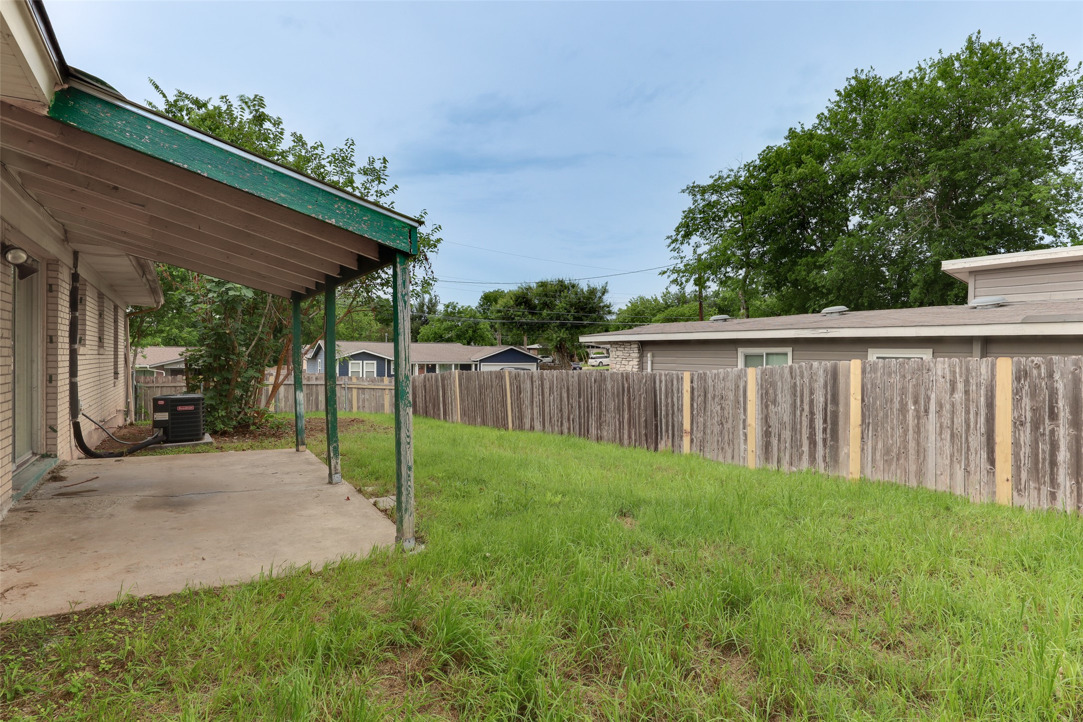 1800 Rhodes Road Austin, TX 78721 - Photo 14 of 14 a view of a backyard with wooden fence