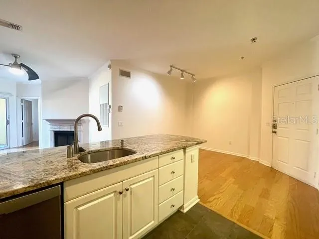a spacious bathroom with a granite countertop sink and a mirror